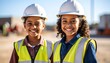 © Bagas - Two young girls smiling in construction site attire