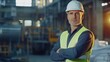 © Daiki - A confident middle-aged male engineer in a hard hat and safety vest stands in an industrial workspace, exemplifying professionalism and leadership.