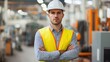 © Daiki - A professional male engineer stands confidently in an industrial setting, wearing safety gear. This portrait captures the essence of his role in engineering and safety management.