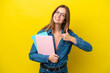 © luismolinero - Young student caucasian woman isolated on yellow background giving a thumbs up gesture