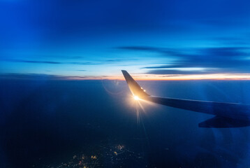 Wall Mural - wing at sunset through the window
