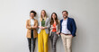 © Moon Safari - Portrait of confident business entrepreneurs standing side by side and smiling at camera against white background
