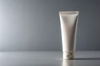 © Lovely - White cosmetic tube on a gray surface and background