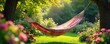 © Buri - Sun-drenched hammock sways gently in a breezy summer garden, overflowing with vibrant flowers and lush greenery Perfect for relaxation and escaping the heat , leisure, rest, lazy