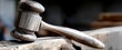 © DIAHIMAGESNEW - Handcrafted wooden gavel resting on a wooden surface