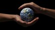© Elzayady - Hands holding a globe against a dark background symbolizing care and environmental responsibility