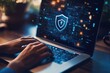 © farisky - Laptop with security shield overlay.  Hands typing on keyboard