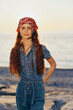 © SHOTPRIME STUDIO - Lifestyle woman in modern boho-western denim street style with a red bandana and long hair at sunset beach, film color tones creating warm, natural mood and authentic vibe.