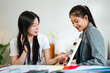 © mojo_cp - Two female experts analyzing personal color palette and guiding client at professional image studio interior