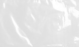 plastic transparent cellophane bag on white background. The texture looks blank and shiny. The plastic surface is wrinkly and tattered making abstract pattern