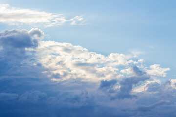 Wall Mural - white cumulus clouds on a blue sky. beautiful nature background in afternoon light. sunny weather in summer