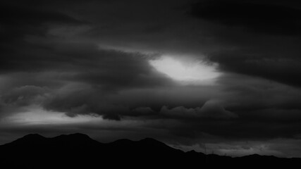 Wall Mural - Background of stormy sky and mountain silhouette