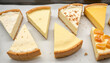 © Marina - Assorted cheesecake slices on a parchment paper background