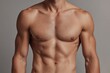 © The Little Hut - Close-up of a Fit Muscular Man's Upper Body Showing Toned Abs Chest and Defined Shoulders with Smooth Skin and No Clothing