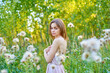 © SergeiPh - A beautiful woman stands in the forest on a summer day. A white dress and transparent panties are dressed on it. The scene is peaceful and serene when the girl is surrounded by nature