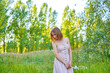 © SergeiPh - A beautiful woman stands in the forest on a summer day. A white dress and transparent panties are dressed on it. The scene is peaceful and serene when the girl is surrounded by nature