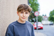 © Irina Schmidt - Portrait of smiling teenage schoolboy looking at camera. Happy teenage boy, smiling confidently into the camera. Portrait of a school kid enjoying student life. Education and youth lifestyle concept.