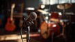 © somsri - Microphone on stand in a rehearsal room with musical instruments in the shadows