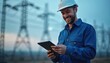 © Viktor - Smiling electrician in blue work clothes, helmet uses tablet outdoors. Power lines on background. Energy tech, engineering, maintenance, infrastructure, industry, innovation. Safety, pro, connection,