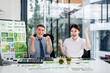 © Freedomz - Happy business professionals celebrate green business success driving ESG environmental social governance initiatives for sustainable future