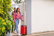 © Guillermo Spelucin - Couple leaving home with suitcases for road trip