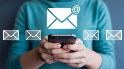 Woman checks messages and email on a mobile device as digital mail notifications appear showing email marketing and online communication strategies.