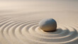 © zeenika - Single gray pebble on smooth sand with concentric raked lines in Japanese Zen garden style representing mental clarity and inner peace.