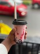 © raveenmathewroy - hand holding a cup of hot drink