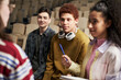 © DragonImages - Group of multiethnic university students including Caucasian teenage boy, Black male and female classmates listening attentively to instructor and taking notes during classroom discussion