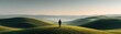 © Thamonchanok - Peaceful finance for balance and long-term planning concept. A solitary figure stands on rolling hills at dawn.