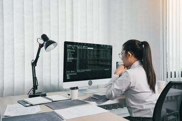 Wall Mural - asian female software developer is worried about analyzing code-based systems at his office.