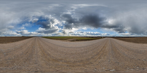 Wall Mural - hdri 360 panorama view on gravel road among fields with clouds in sky in equirectangular full seamle