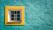© PhotoHub - A bright yellow framed window set into a textured turquoise blue stucco wall on a sunny day