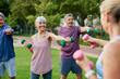 © Rido - Senior people lifting dumbbells at city park