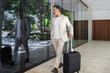 © ADDICTIVE STOCK - Indian man with suitcase explores modern urban landscape