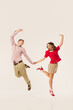 © Lustre Art Group  - A retro couple energetically dances the lindy hop, showcasing joyful expressions and coordinated outfits. Concept of vintage dance revival and joyful movement.
