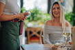 © Zamrznuti tonovi - Waitress holding pos terminal for contactless payment in restaurant