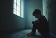 © Giuseppe Cammino - A young boy sitting alone in a dark corner, reflecting despair and vulnerability