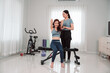 © Kiattisak - Asian Woman Lifestyle Friends Training Fitness Sport Fit Exercise , Two Female Active Enjoying a Healthy Home Workout Routine Together for Wellness, Balance, and Motivation in the Living Room