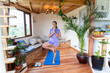 © ADDICTIVE STOCK - Woman practices yoga at home in a peaceful setting
