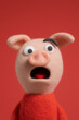 © Niaz - Surprised pink pig puppet character made of felt with wide open mouth and big eyes on red background for comic children animation illustration