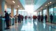 © narumon - Blurred image of people queuing at a modern indoor service counter, business or government office environment, bright lighting with large windows and digital queue displays, public service scene