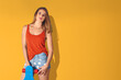 © Svetlana Radayeva - A cheerful young woman with a skateboard on a yellow background. for youth lifestyle, summer fun, sports, and casual fashion themes in ads or designs.