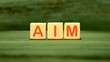 © Garik - The AIM concept word is assembled from cubes. Business concept