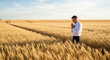 © Ediane - A man praying in a golden wheat field under a bright sky.