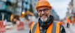 © Ilja - Cheerful Construction Supervisor Wearing Hard Hat, Overseeing Safety in Busy Construction Zone Site