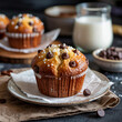 © Rahmat Chowdhury - A chocolate chip muffin on a plate with milk and chocolate chips in background