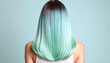 © phadobo - Back angle view of a woman with sleek two-tone pastel hair, mint green transitioning smoothly into baby blue, smooth texture, cool-toned soft lighting, minimalistic background