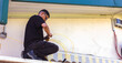 © PintoArt - Technician installing fiber optic cable on building exterior