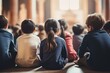 © nsit0108 - Large group of diverse elementary school students sitting on the floor listening attentively to their teacher